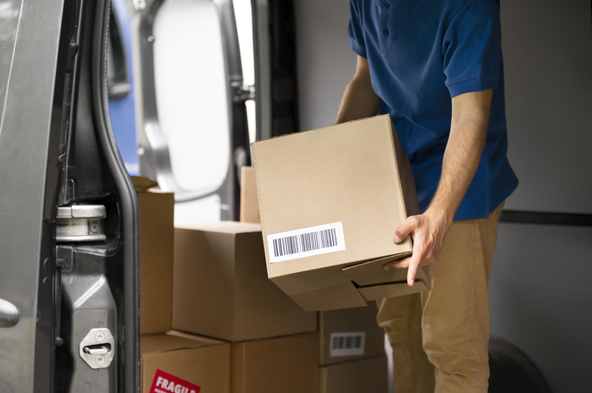 A close-up of hands holding a cardboard box, symbolizing efficient logistics, shipping, and supply chain management in global trade.
